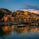 Hoi An ancient town at dusk with colourful silk lanterns reflected in the Thu Bon river
