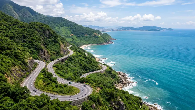 Hai Van Pass coastal road winding along the mountainside above the sea
