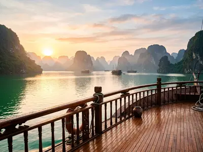 Ha Long Bay limestone karsts viewed from a junk boat deck at dawn
