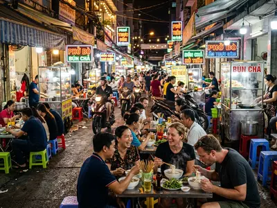 Saigon street food alley with steaming bowls and neon signs