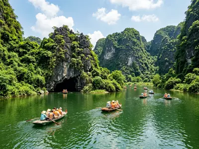 Trang An rowing boats passing through limestone karst cave in Ninh Binh